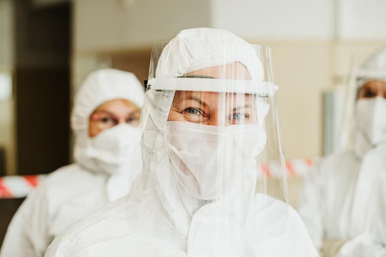 Three people wearing PPE