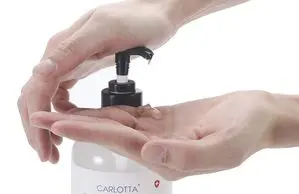 A hand using a sanitizer